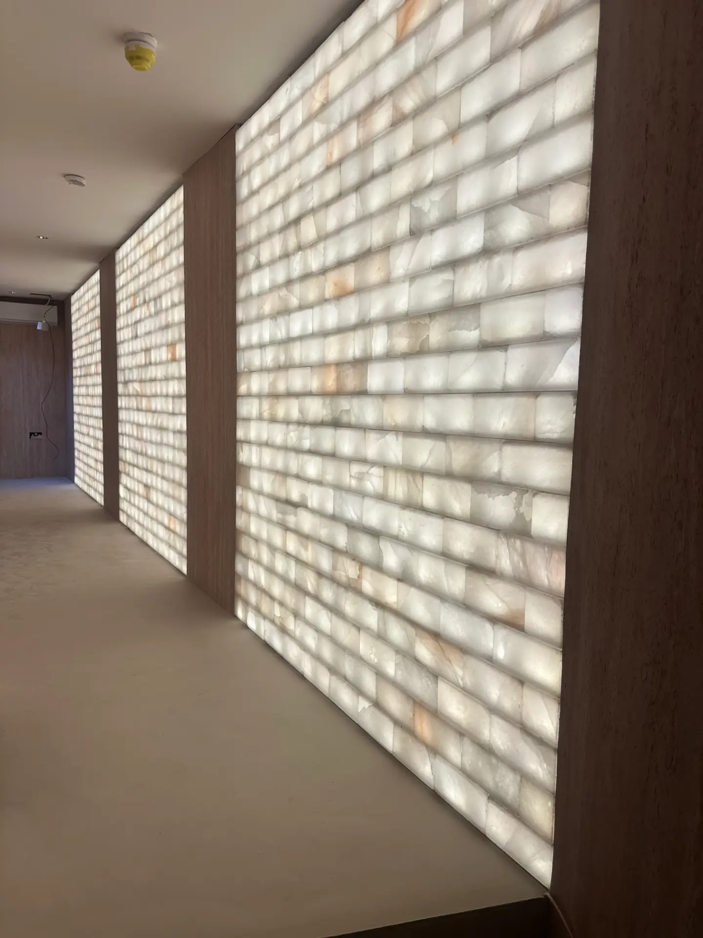 Private clinic wellness room with a softly illuminated white salt wall